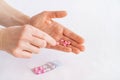 Tablets in hand on a white background close-up. Royalty Free Stock Photo