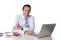 40 to 50 years old senior businessman working on computer at office desk looking confident and relaxed Royalty Free Stock Photo