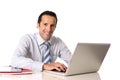 40 to 50 years old senior businessman working on computer at office desk looking confident and relaxed