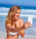 To you - beach selfie. A beautiful, young woman having fun at the beach. Royalty Free Stock Photo