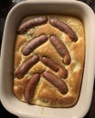 Toad in he hole taken from the oven in a ceramic form Royalty Free Stock Photo