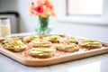 toast with almond butter topped with apple slices arranged on steel tray