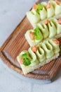 Toast with avocado mousse and cream cheese with salmon sevice with lime juice and mint.