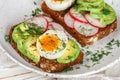 Toast with avocado, radish, egg and flax seeds Royalty Free Stock Photo