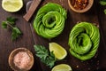 Toast with avocado roses on wooden cutting board