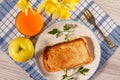 Toast with butter and cheese on white plate, apple, glass of ora Royalty Free Stock Photo