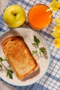 Toast with butter and cheese on white plate, apple, glass of ora Royalty Free Stock Photo