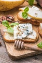 Toast or canape with goat cheese, basil, honey, nuts. Delicious appetizer, ideal as an aperitif