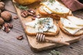 Toast or canape with goat cheese, thyme, honey, nuts. Delicious appetizer, ideal as an aperitif