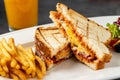 Toast with cheese, egg and Turkish sausage served with salad and french fries on white plate Royalty Free Stock Photo