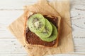 Toast with choco cream and kiwi on wooden background