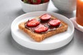 Toast with chocolate spread and strawberries on grey table, closeup. Healthy breakfast Royalty Free Stock Photo