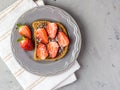 Toast with chocolate and strawberry, Single sandwich with chocolate cheese on white plate, top view Royalty Free Stock Photo