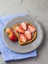 Toast with chocolate and strawberry, Single sandwich with chocolate cheese on white plate, top view Royalty Free Stock Photo