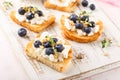 Toast with fresh berries blueberry Ricotta cheese, thyme, honey and hazelnuts, served