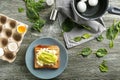 Toast with cut avocado and boiled egg on wooden table Royalty Free Stock Photo