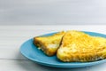 toast in an egg on a blue plate. Breakfast