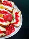 Toast filled with strawberry jam on a round plate Royalty Free Stock Photo