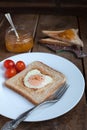 Toast with fried egg in the shape of heart and cherry tomatoes Royalty Free Stock Photo