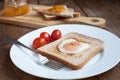 Toast with fried egg in the shape of heart and cherry tomatoes Royalty Free Stock Photo