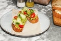 Toast with guacamole sauce and fresh vegetables. Appetizing sandwiches with avocado, cucumber, cherry tomatoes and herbs.