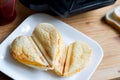 Toast heart shape with toaster sandwich maker love valentines breakfast concept Royalty Free Stock Photo