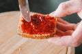 Toast with jam. bun with raspberry jam.Sweet breakfast. hands spread raspberry jam on a grain bun