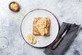 Toast with peanut butter, banana slices, honey and almond flakes on old gray concrete background. Royalty Free Stock Photo