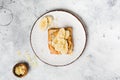 Toast with peanut butter, banana slices, honey and almond flakes on old gray concrete background Royalty Free Stock Photo