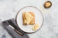 Toast with peanut butter, banana slices, honey and almond flakes on old gray concrete background. Top view Royalty Free Stock Photo