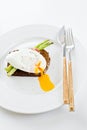 Toast with poached egg and baked asparagus. White background, side view. Royalty Free Stock Photo