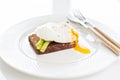 Toast with poached egg and baked asparagus. White background, side view. Royalty Free Stock Photo