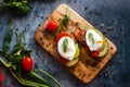 Toast with poached eggs, tomatoes, avocado, spices and herbs Royalty Free Stock Photo