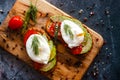 Toast with poached eggs, tomatoes, avocado, spices and herbs Royalty Free Stock Photo