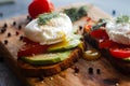 Toast with poached eggs, tomatoes, avocado, spices and herbs Royalty Free Stock Photo