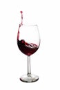 A Toast with Red Wine. Splash, white background. Splashing red wine on balloon glasses Royalty Free Stock Photo