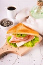 Toast sandwich with ham, cheese and herbs on a wooden board on the table vertical view Royalty Free Stock Photo