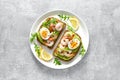 Toast with shrimps, avocado guacomole, arugula and boiled egg Royalty Free Stock Photo