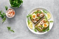 Toast with shrimps, avocado guacomole, arugula and boiled egg, top view Royalty Free Stock Photo