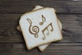 Toast with the sign of music on dark wood