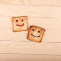 Toast with a smile jam on wooden table