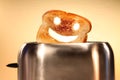 Toast with smiley face in toaster Royalty Free Stock Photo