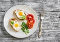 Toast with soft cheese and quail eggs on a white plate Royalty Free Stock Photo