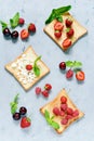 Toast with strawberries, raspberries, cherries, mint and cottage cheese for breakfast. Healthy breakfast, Ruddy bread toast. Royalty Free Stock Photo