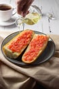 Toast with tomato, traditional Spanish breakfast. Olive oil is poured from a glass jug, side view. Pan tumaka Royalty Free Stock Photo