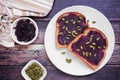 Toast with ube halaya jam and pumpkin seeds. Table scene on a dark wood background. Royalty Free Stock Photo