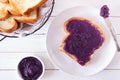 Toast with ube halaya, purple yam spread on a white wood background Royalty Free Stock Photo