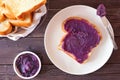 Toast with ube halaya, purple yam spread on a dark wood background Royalty Free Stock Photo