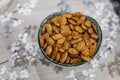 Toasted almonds on a bowl on a table with floral black and white decoration Royalty Free Stock Photo