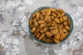 Toasted almonds on a bowl on a table with floral black and white decoration